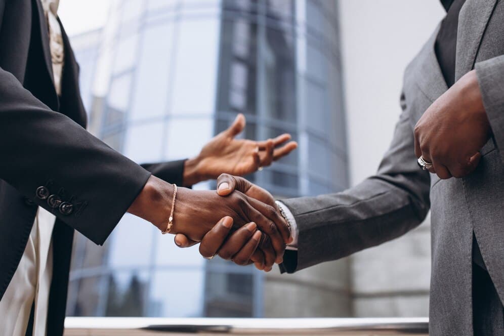 Business professionals completing a successful partnership handshake