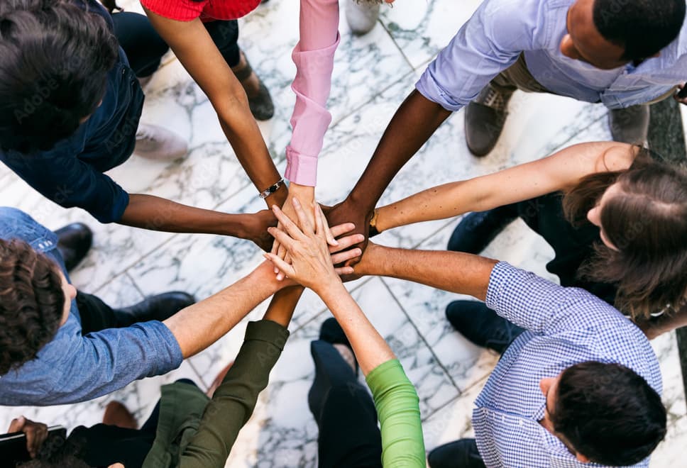 A diverse group of hands joined in solidarity